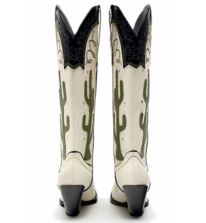 White cowboy boots with black accents and cactus design on a white background