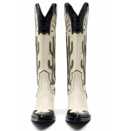 White cowboy boots with black accents and cactus design on a white background