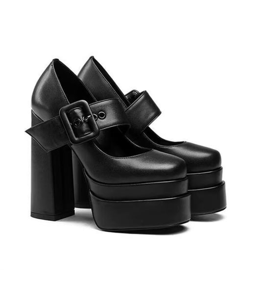 Black platform shoes with buckles on a white background